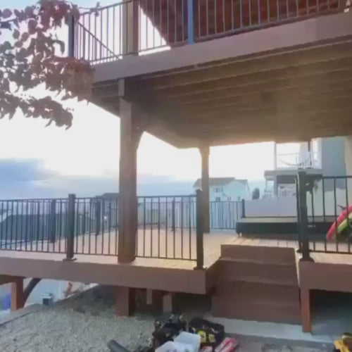 Load video: beautiful 2 story deck with covered custom wood and metal roof trex composite decking and powder coated metal handrail